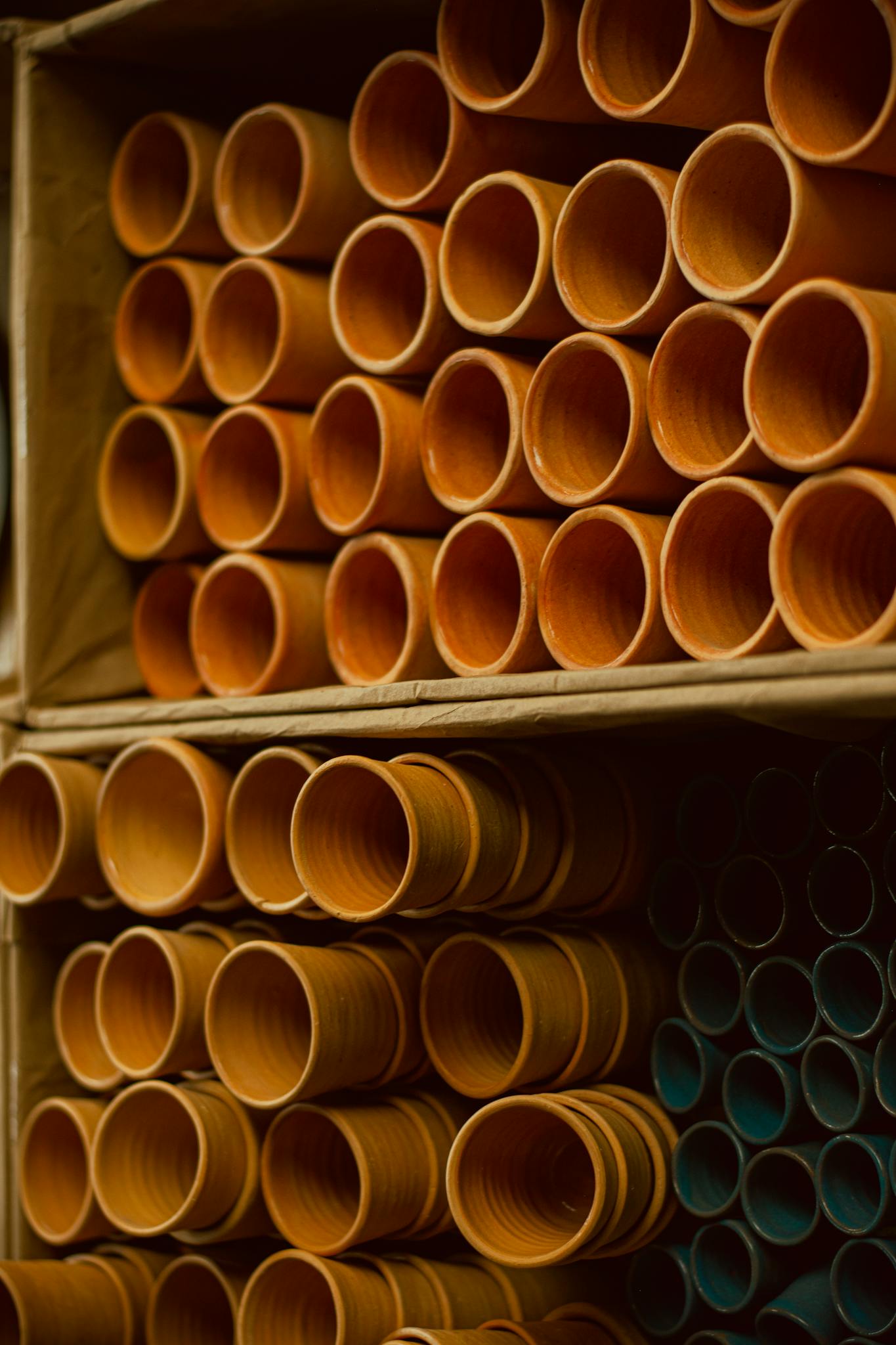 Organized rows of industrial pipes in a warehouse setting showcasing manufacturing and construction materials.